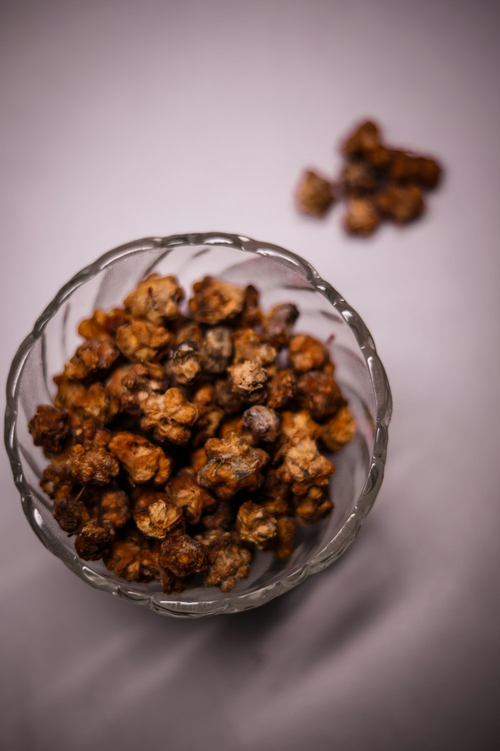 brown nuts in clear glass bowl