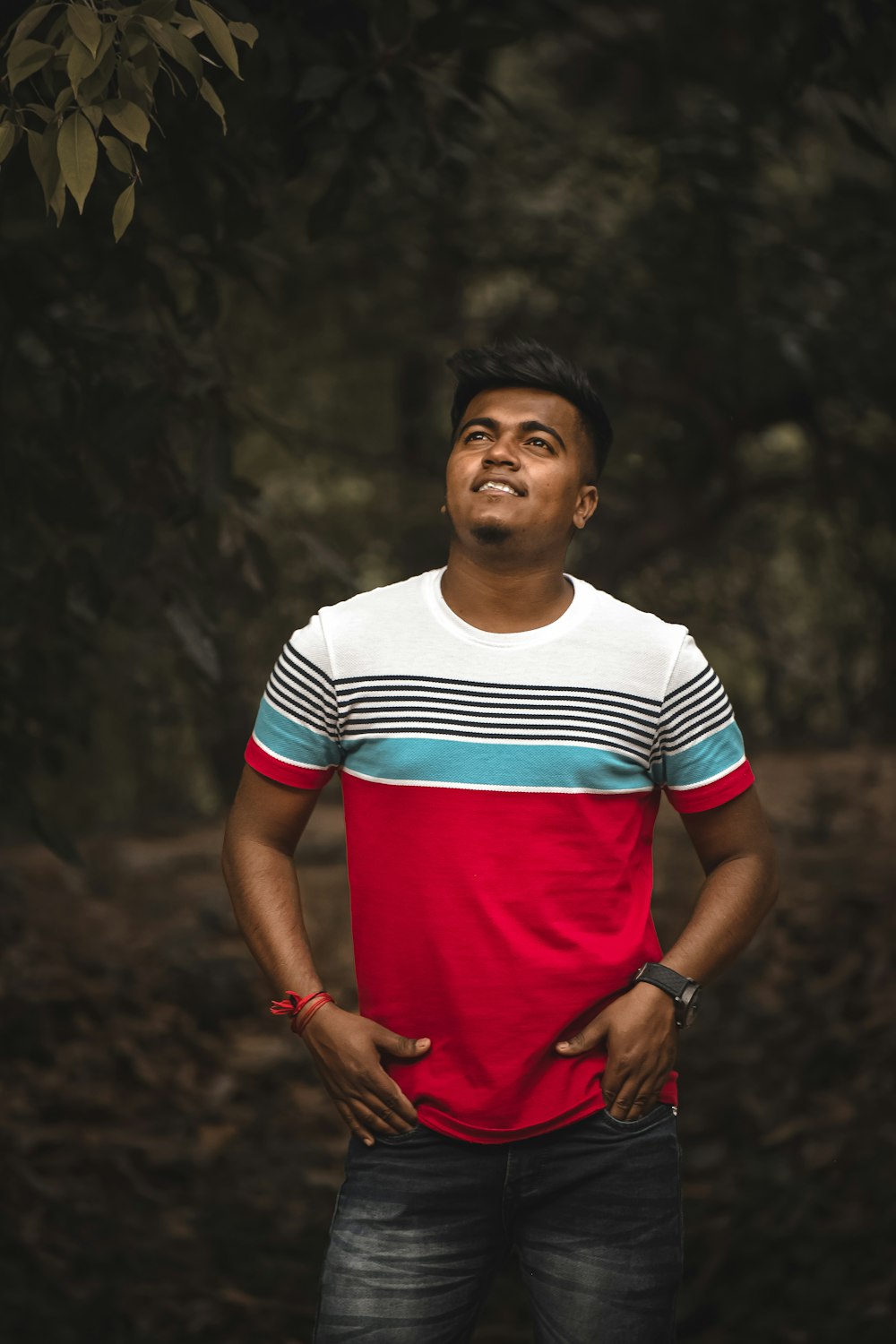 Homme en T-shirt à col rond rayé rouge, blanc et bleu