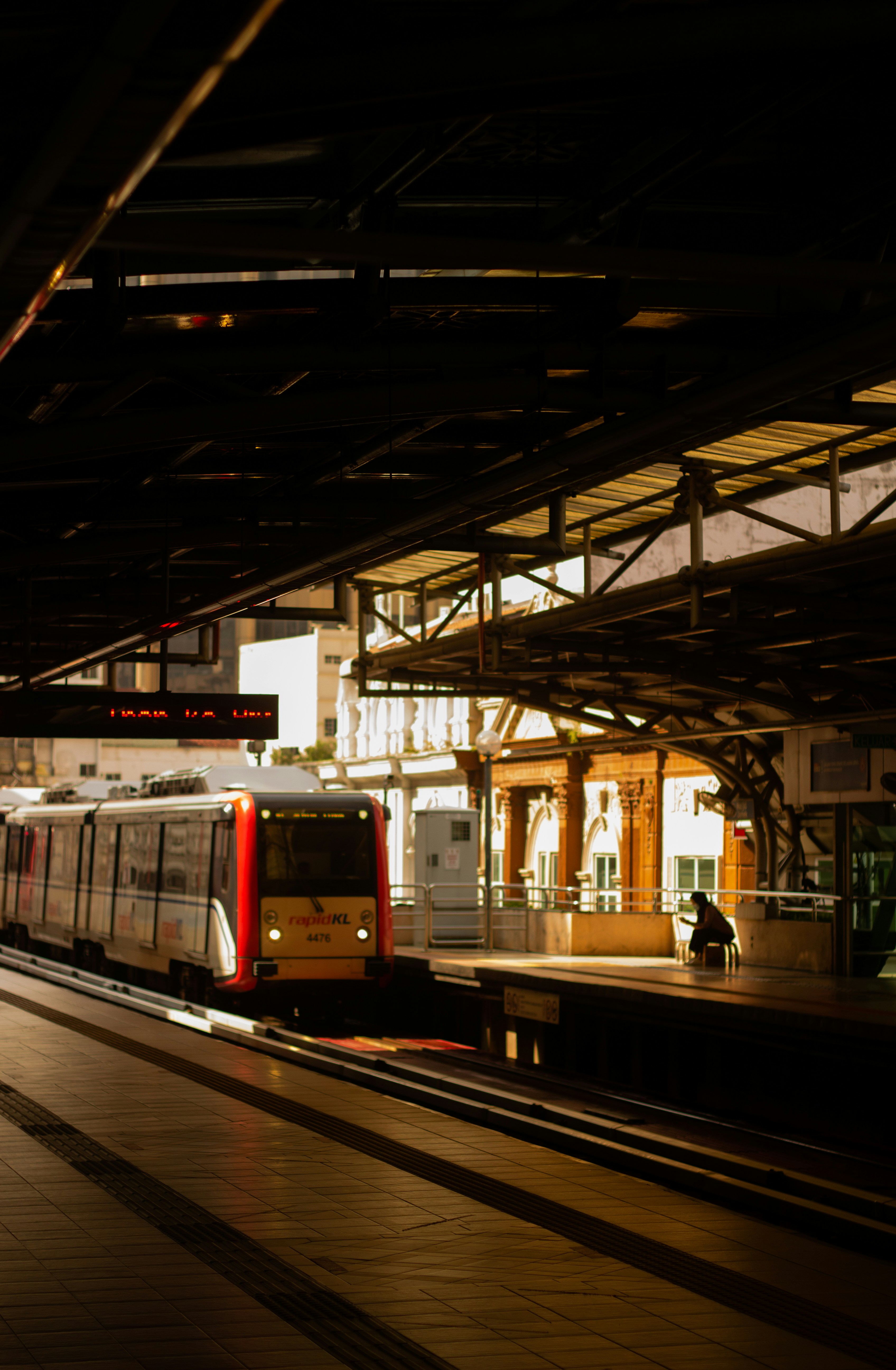 white and red train in train station