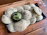Close-up of a rustic plate filled with steaming hot litti chokha, garnished with fresh coriander.