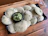 Close-up of a rustic plate filled with steaming hot litti chokha, garnished with fresh coriander.