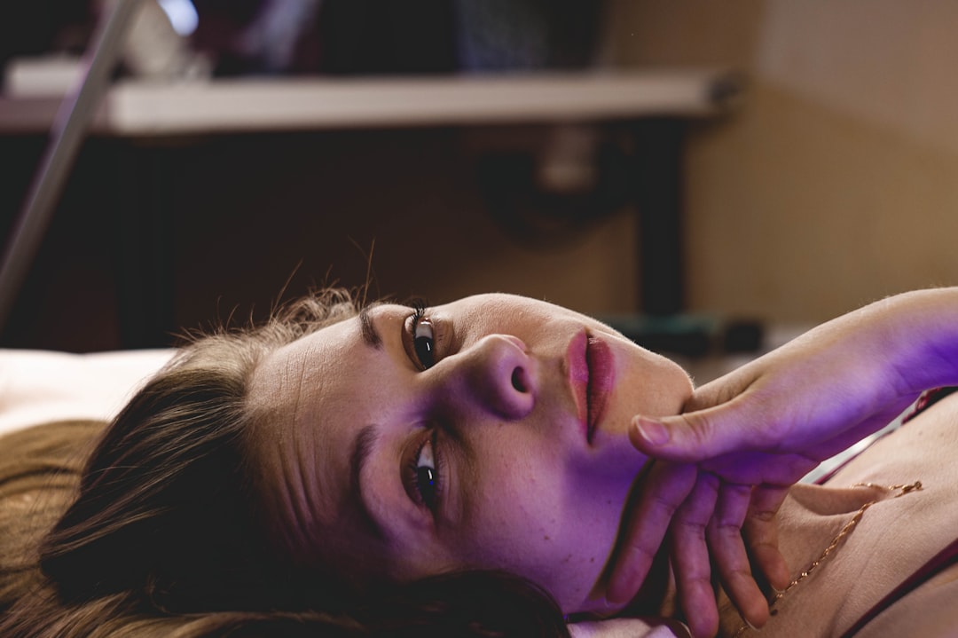 woman lying on bed with eyes closed