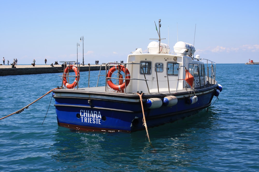 black and white boat on sea during daytime