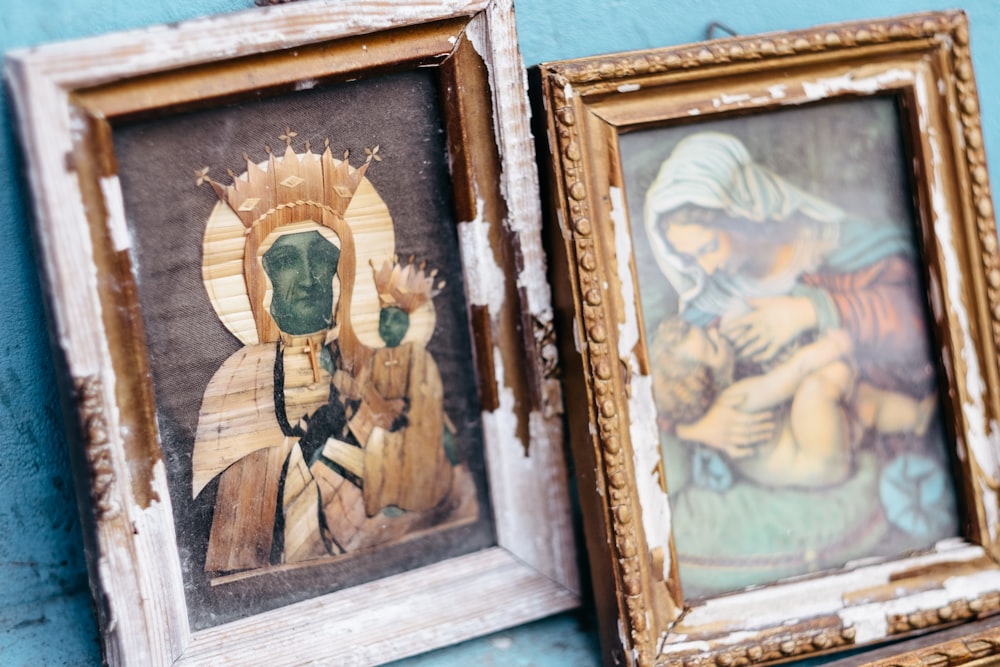 brown wooden framed painting of man and woman