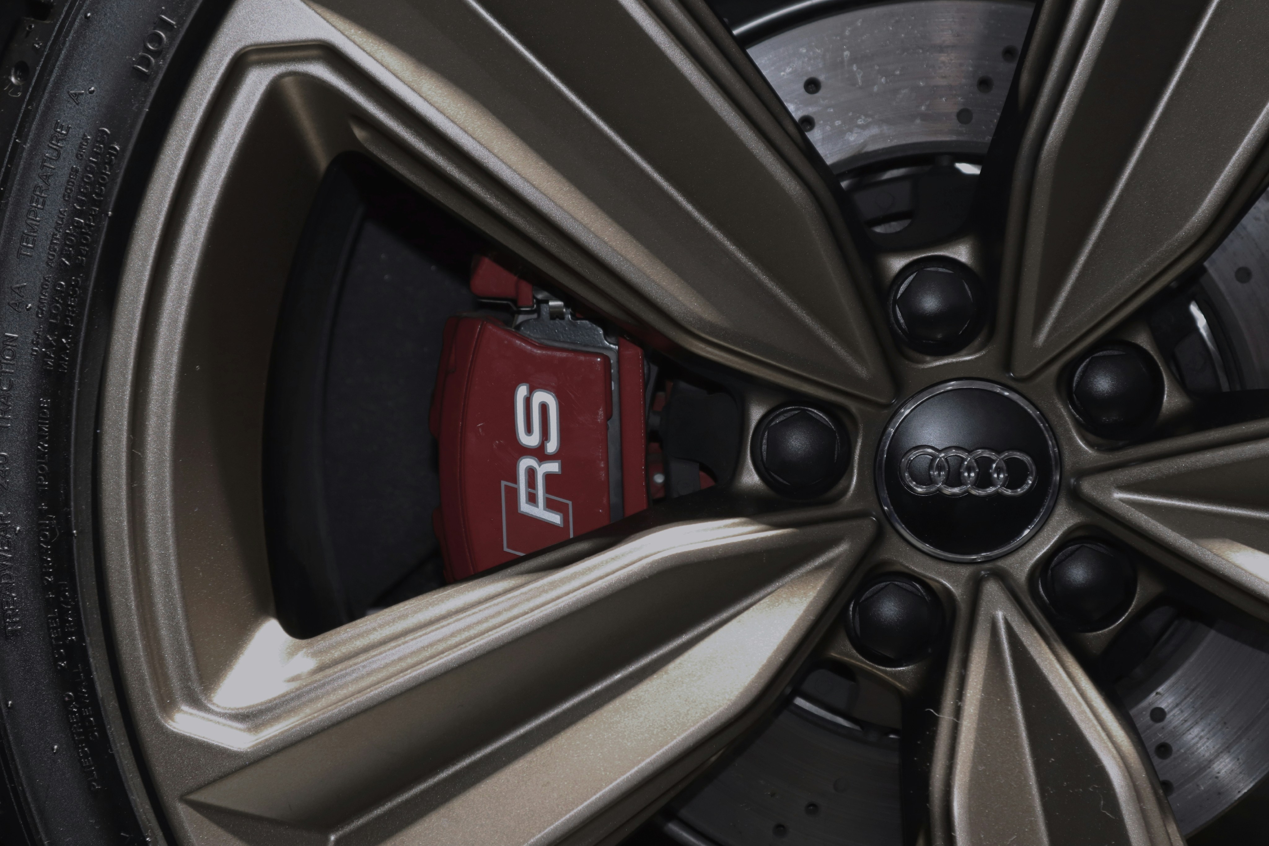 Close-up of a Tesla electric car logo on the front of the vehicle