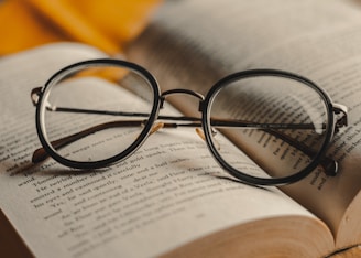 black framed eyeglasses on book page