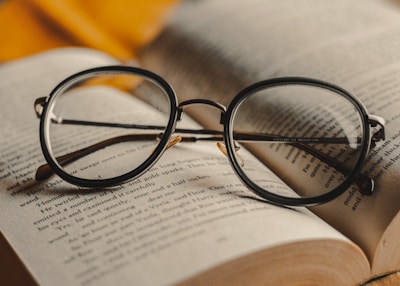 black framed eyeglasses on book page