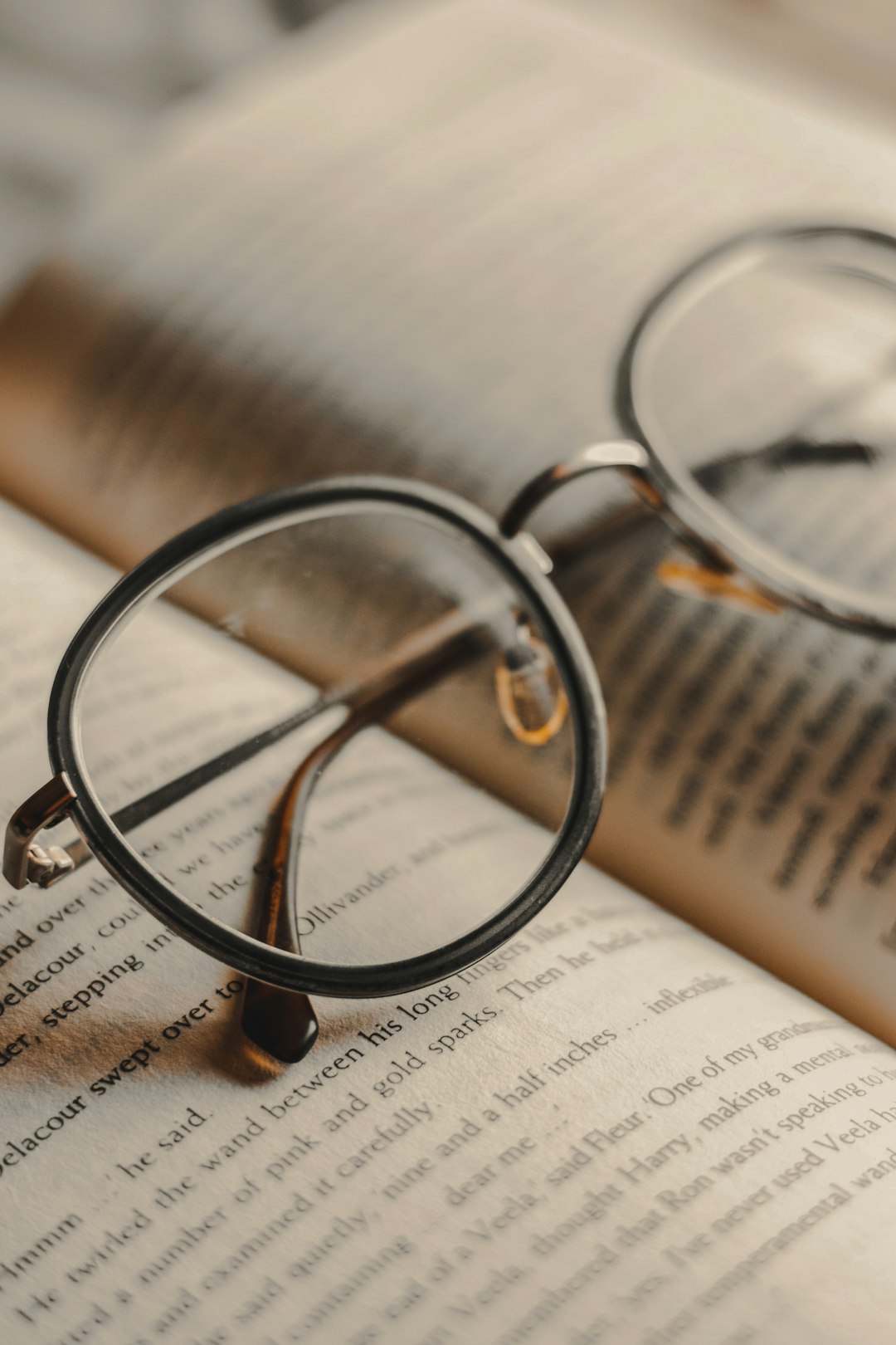 silver framed eyeglasses on book page