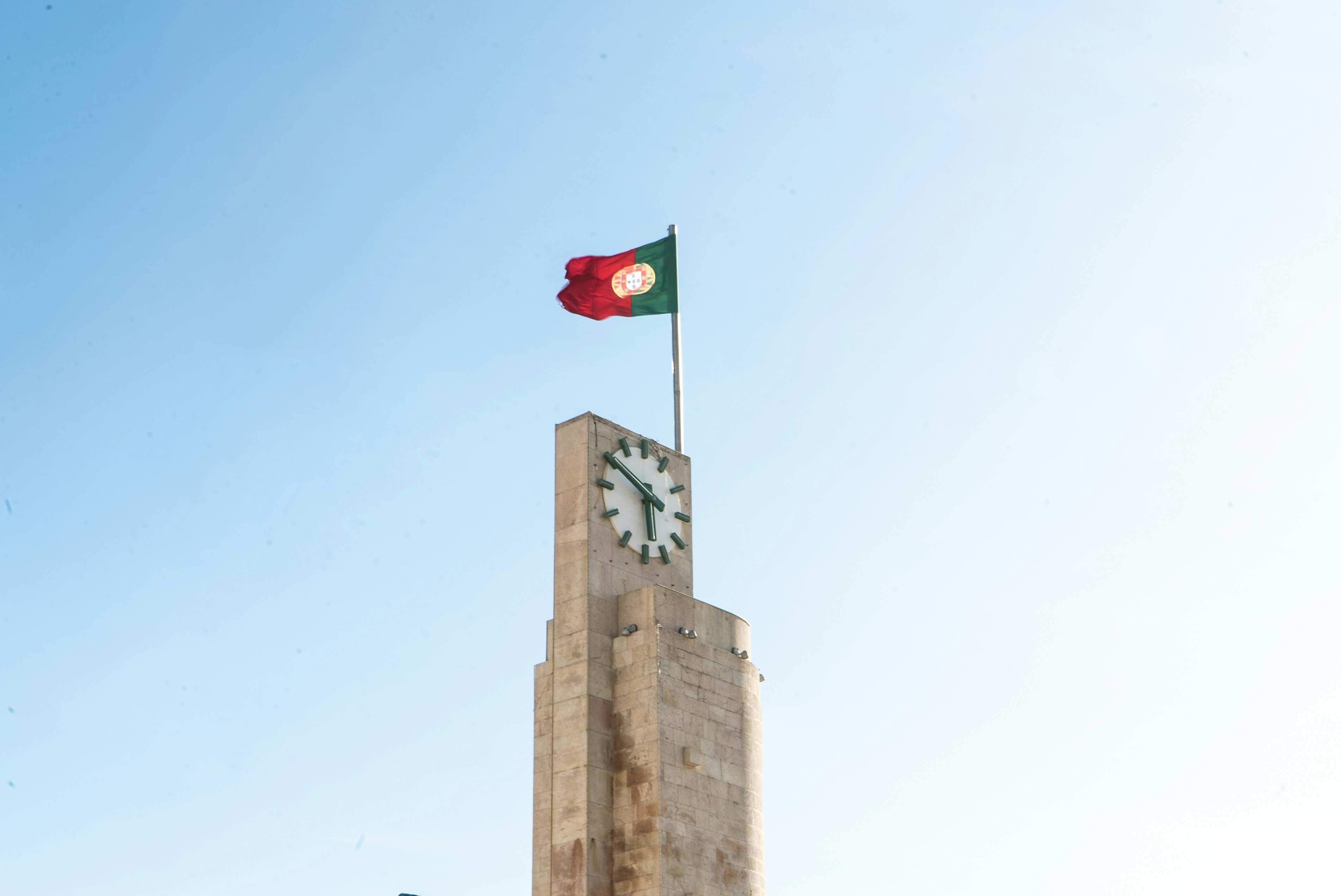 red white and green flag on brown concrete building during daytime
