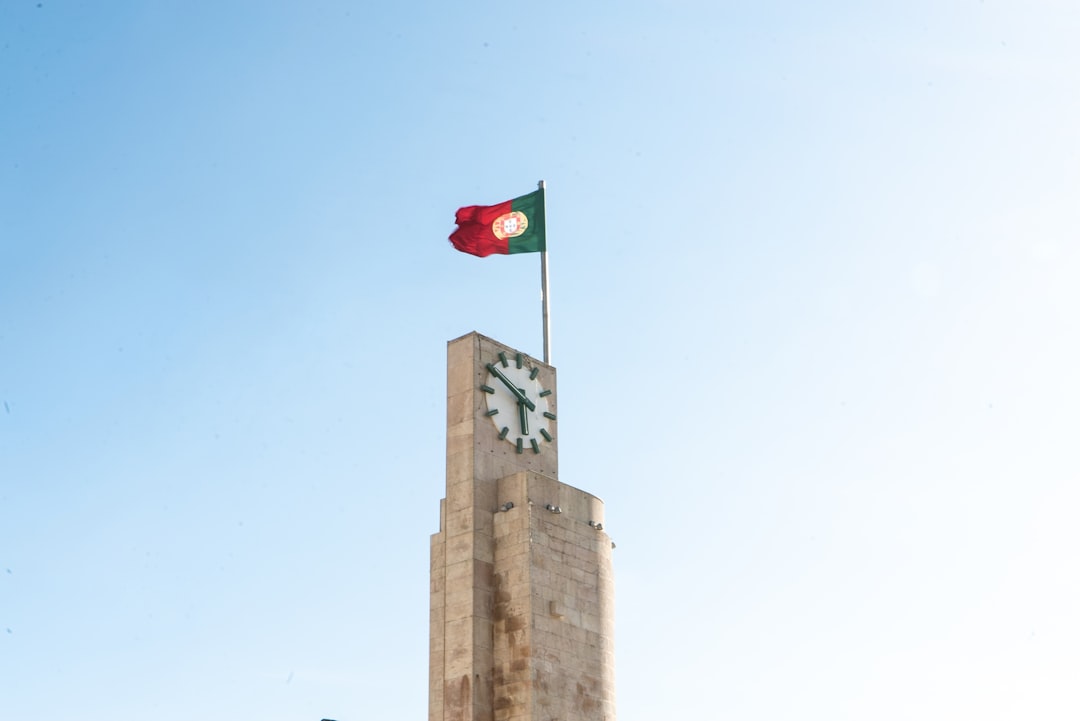 red white and green flag on brown concrete building during daytime