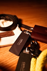 A collection of leather accessories arranged neatly on a soft fabric.