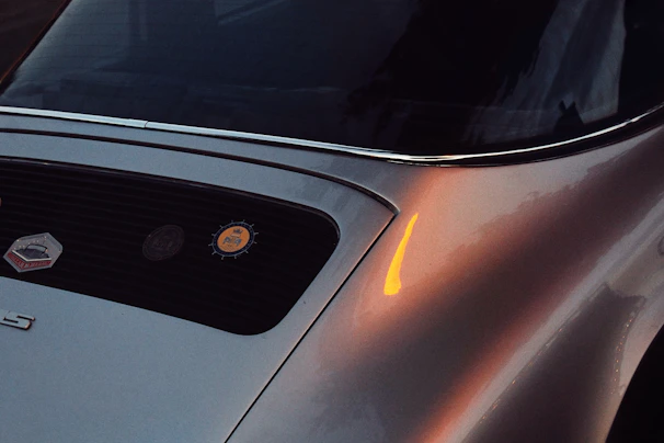 Close-up of a vintage car’s polished chrome grille reflecting the warm Mallorcan sunset.