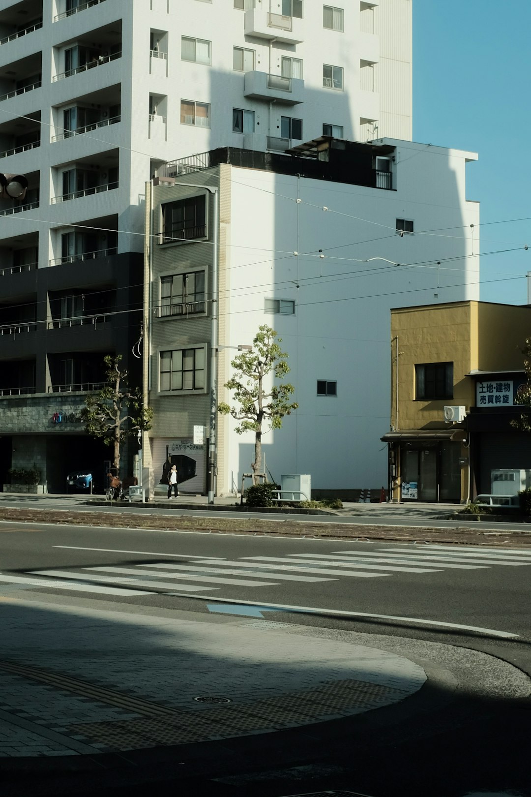 white and black concrete building beside road during daytime