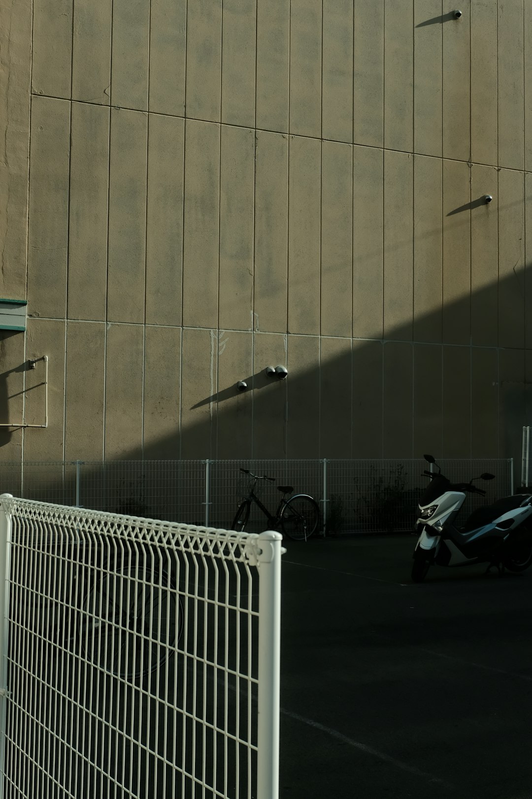 white metal fence near black motorcycle