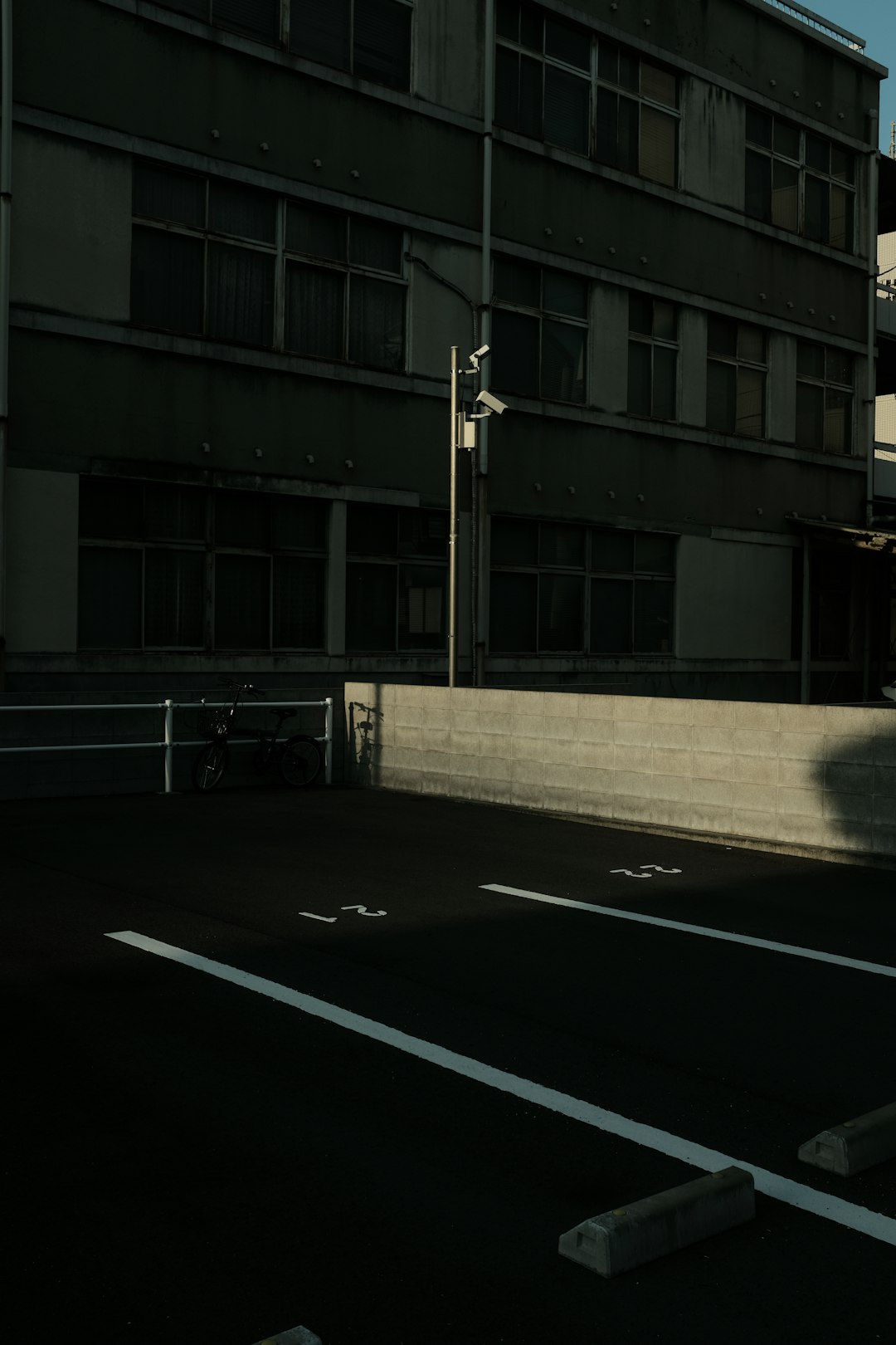 black car parked beside building