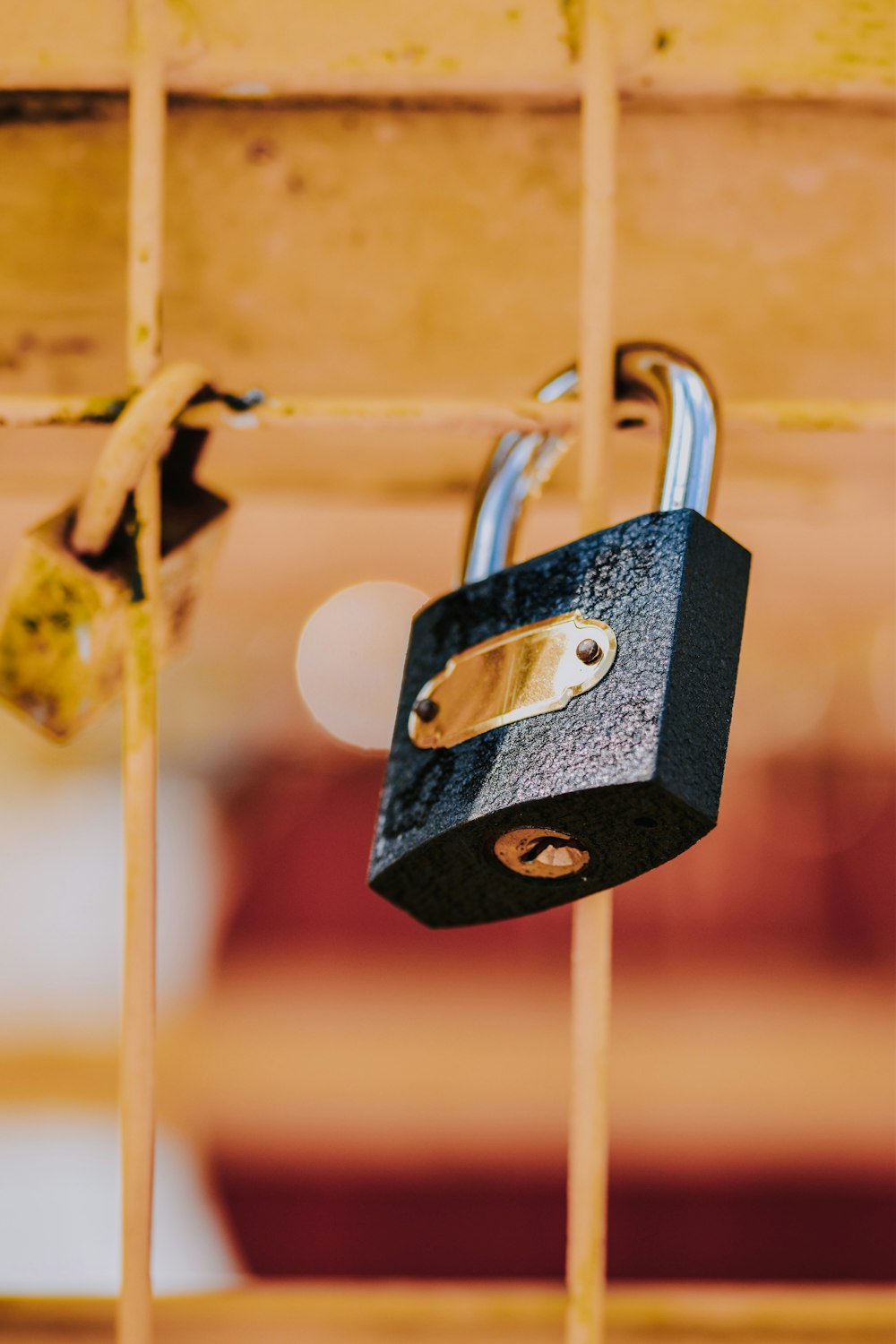 grey padlock on brown metal wire