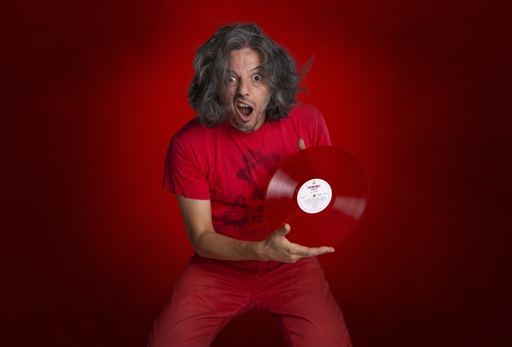 man in red crew neck t-shirt and red pants sitting on red floor