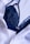 A dark blue lace bra is partially covered by a white button-up shirt. The fabric of both the bra and the shirt appears to be of fine texture, with the bra having intricate lace details and the shirt having a smooth, slightly crinkled texture.