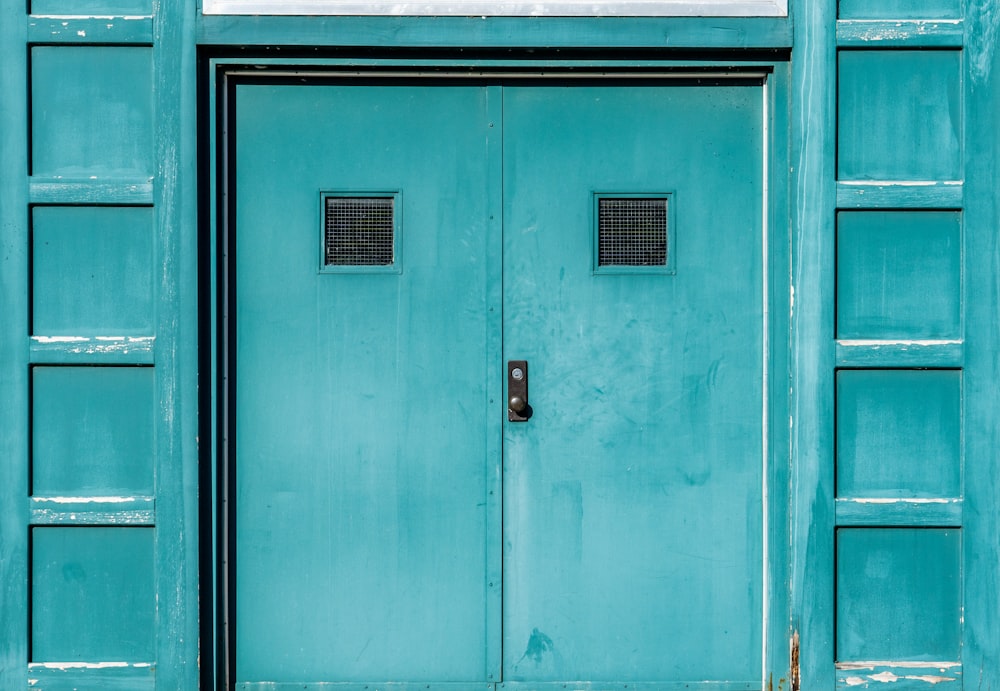 blue wooden door with black steel door lever