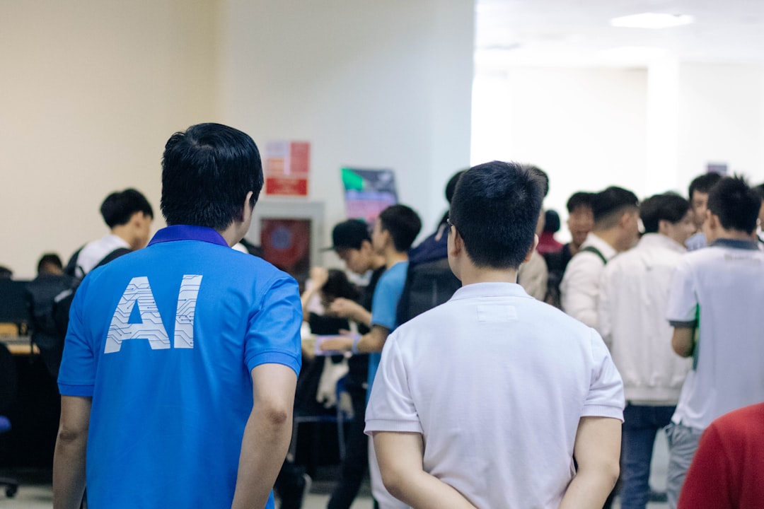 man in white and blue crew neck t-shirt standing in front of people,