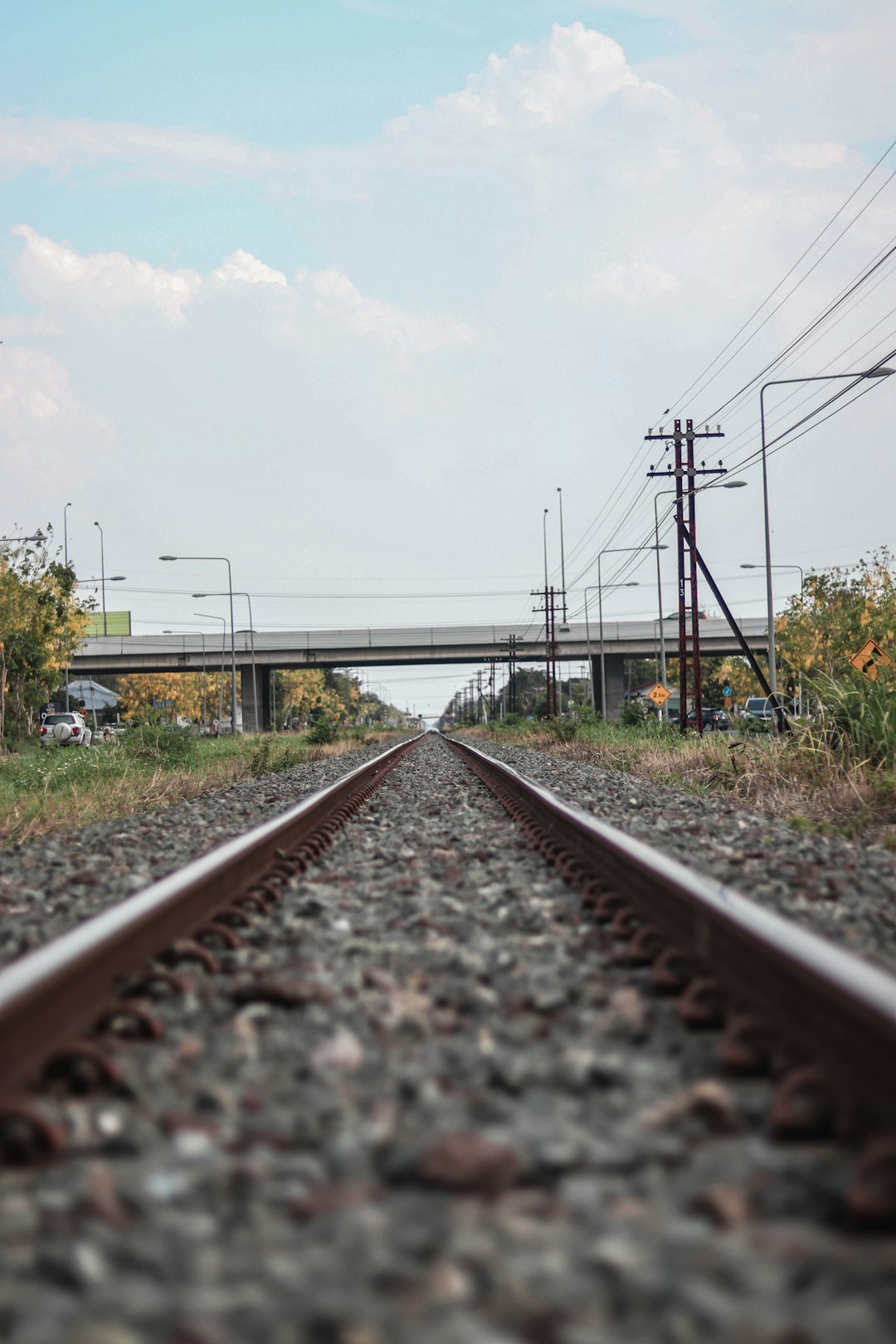 train rail under white sky during daytime