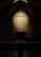 A serene church interior with soft lighting highlighting a simple wooden cross.