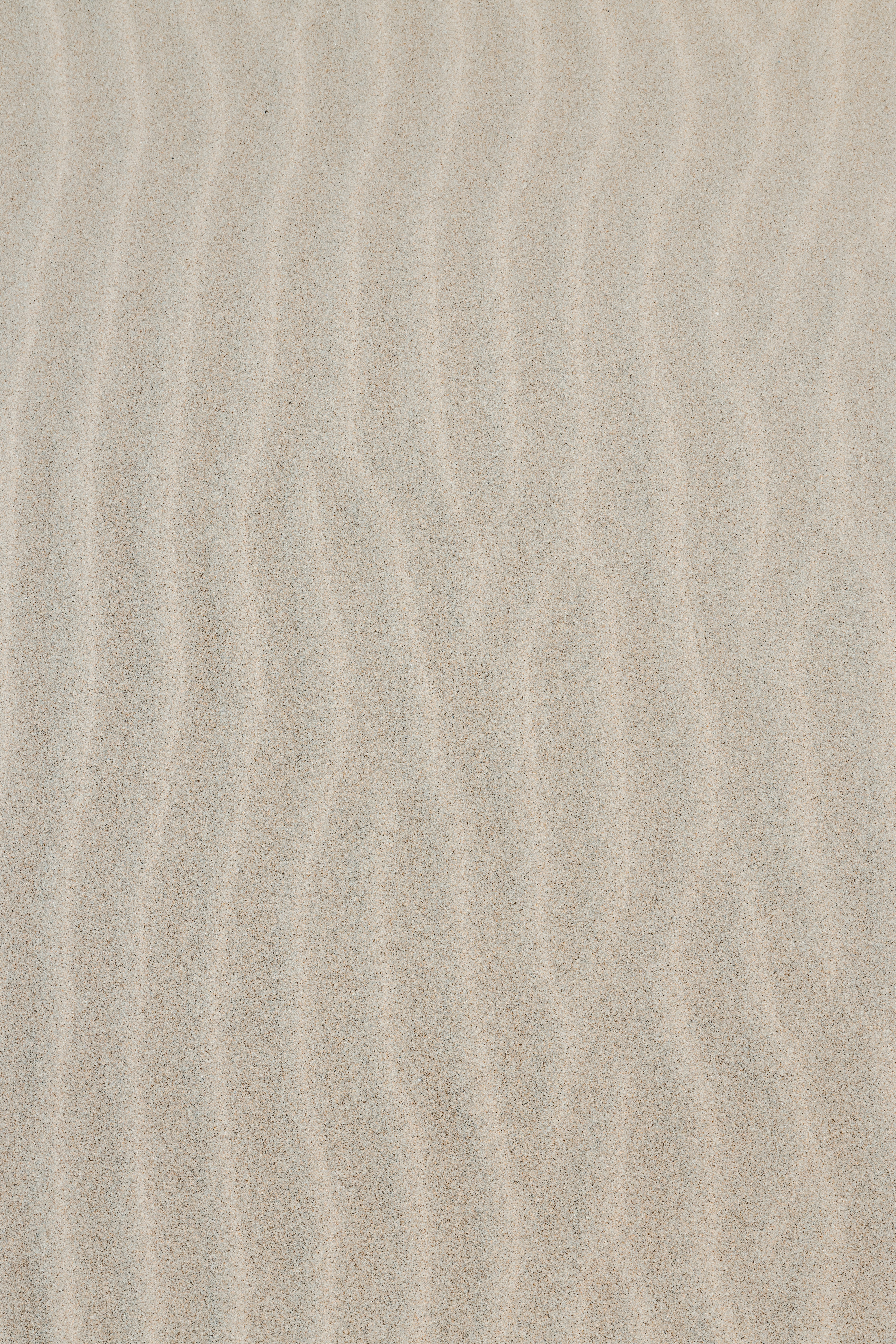 Top shot of some beach sand forming waves with pastel tones. Sand waves for texture background