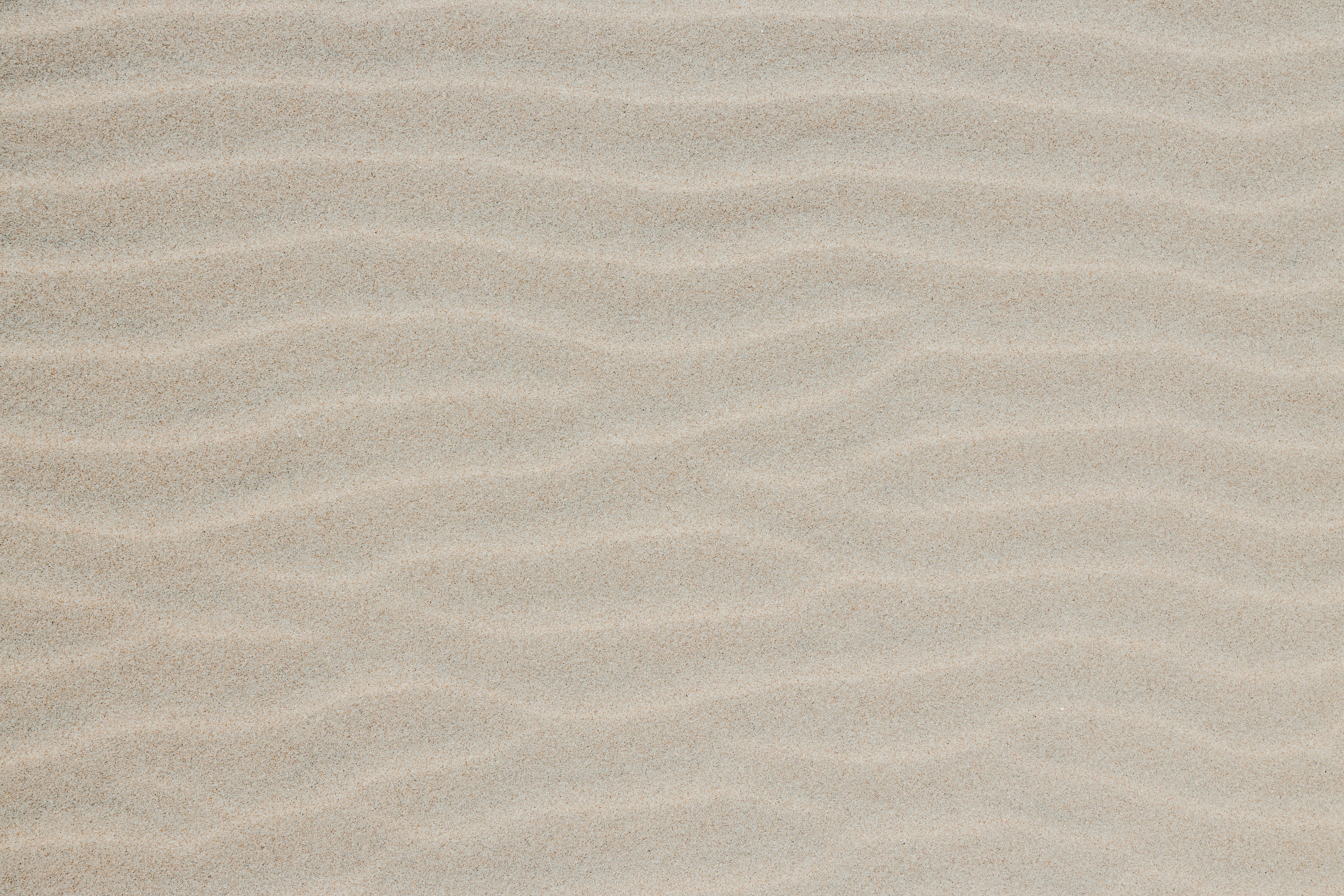 Top shot of some beach sand forming waves with pastel tones. Sand waves for texture background