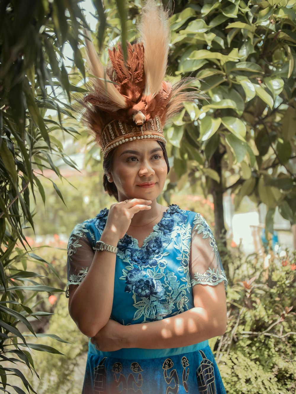 woman in blue and white floral sleeveless dress wearing gold crown