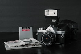 black and silver nikon dslr camera on white paper