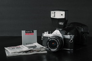 black and silver nikon dslr camera on white paper