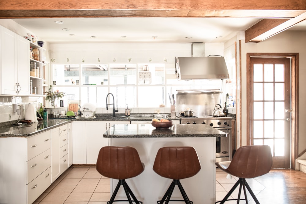 brown wooden bar stools beside kitchen counter