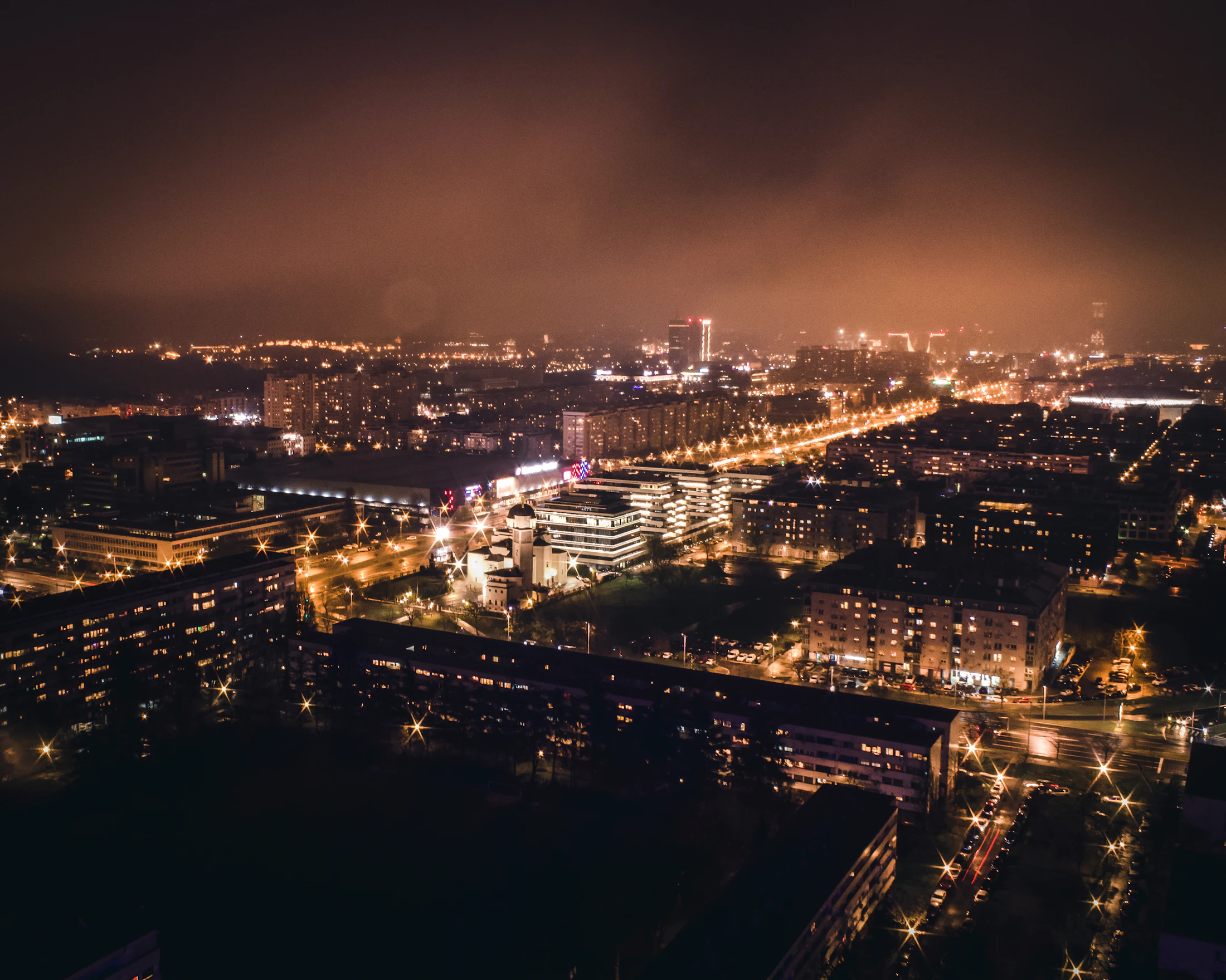 Belgrade cityscape illuminated at night above the Sava confluence