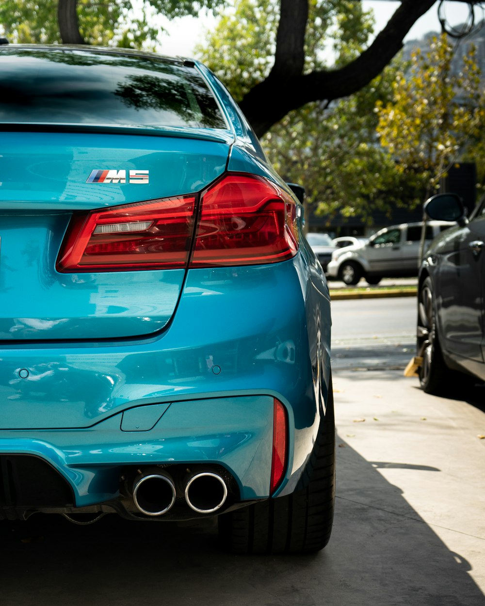 blue bmw m 3 on road during daytime