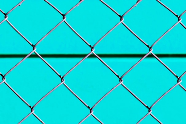 blue metal fence with chain link fence