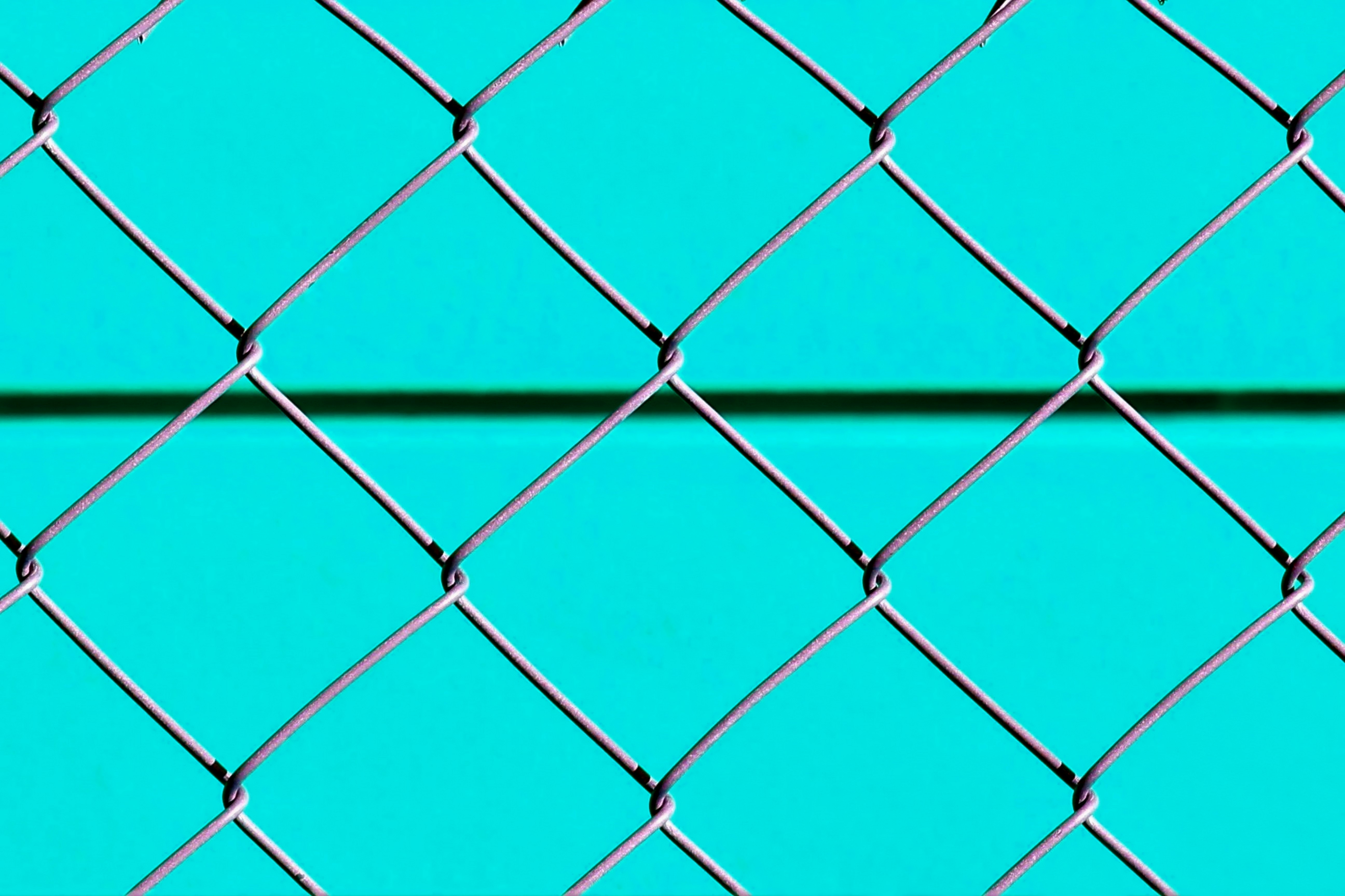 blue metal fence with chain link fence