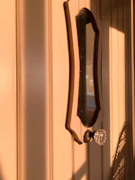 The same door fully restored with fresh paint and new hardware, glowing in natural light.