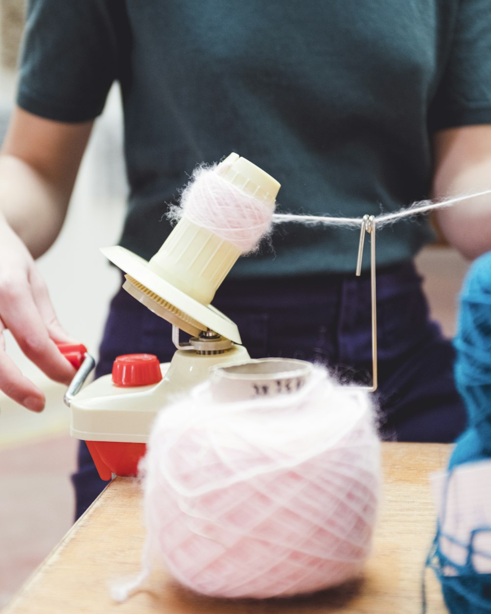 person holding white thread roll