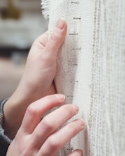 person holding white braille paper