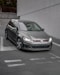 black mercedes benz c class coupe parked beside white wall