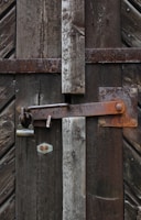 padlock on brown wooden fence