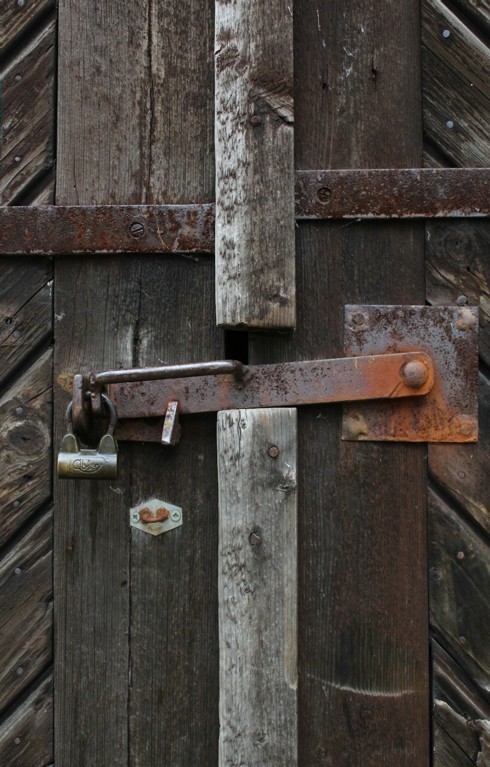 padlock on brown wooden fence