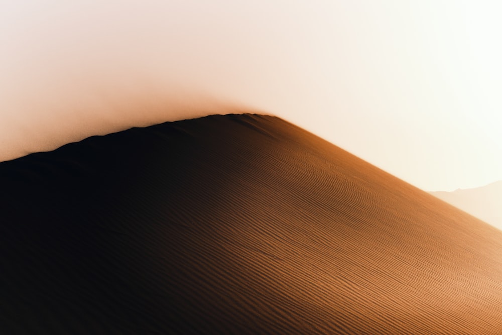 brown sand under white sky during daytime