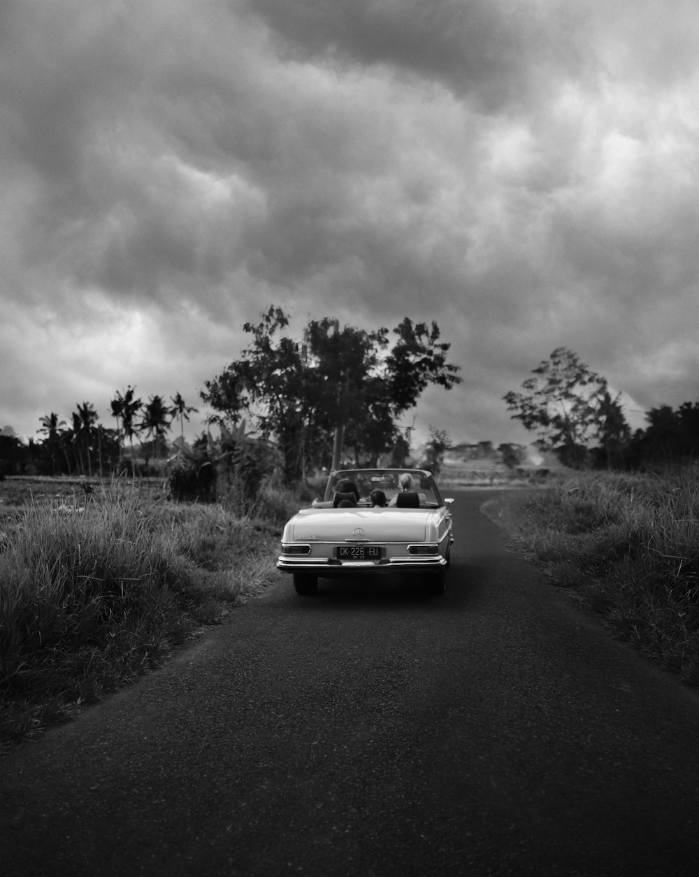 grayscale photo of car on road