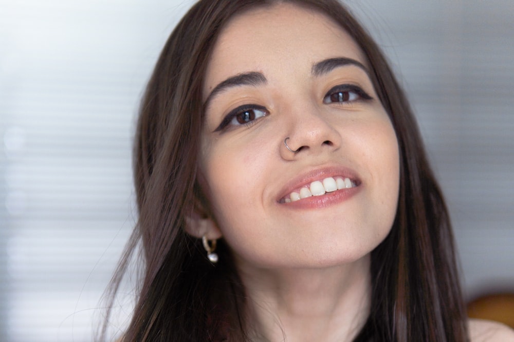 woman in silver earrings smiling