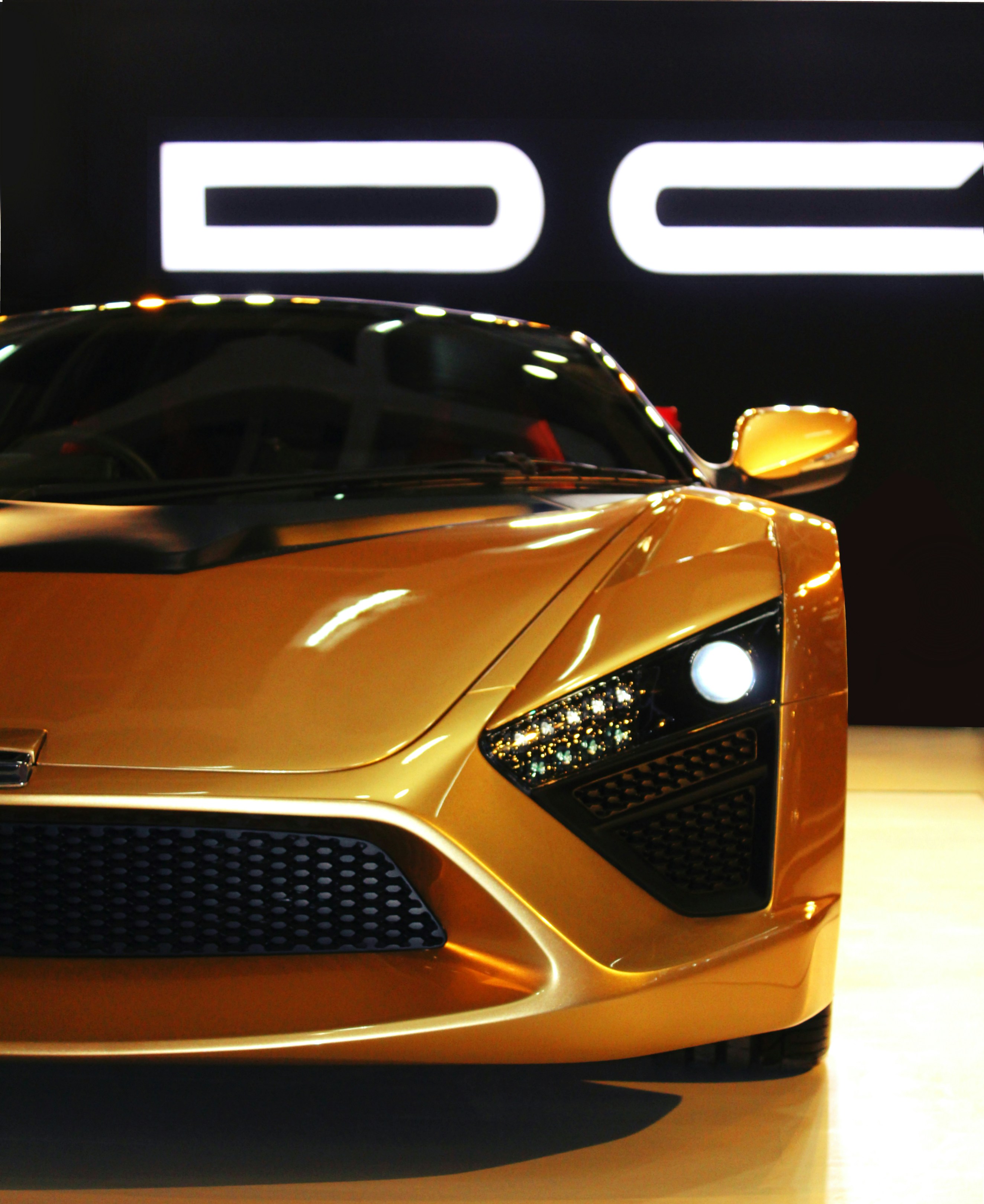 orange porsche 911 parked on white floor