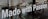 The image features a glass window with the phrase 'Made with Passion' prominently displayed in white text. Behind the glass, there is a blurred view of a street scene, including a bicycle and some indistinct urban elements.