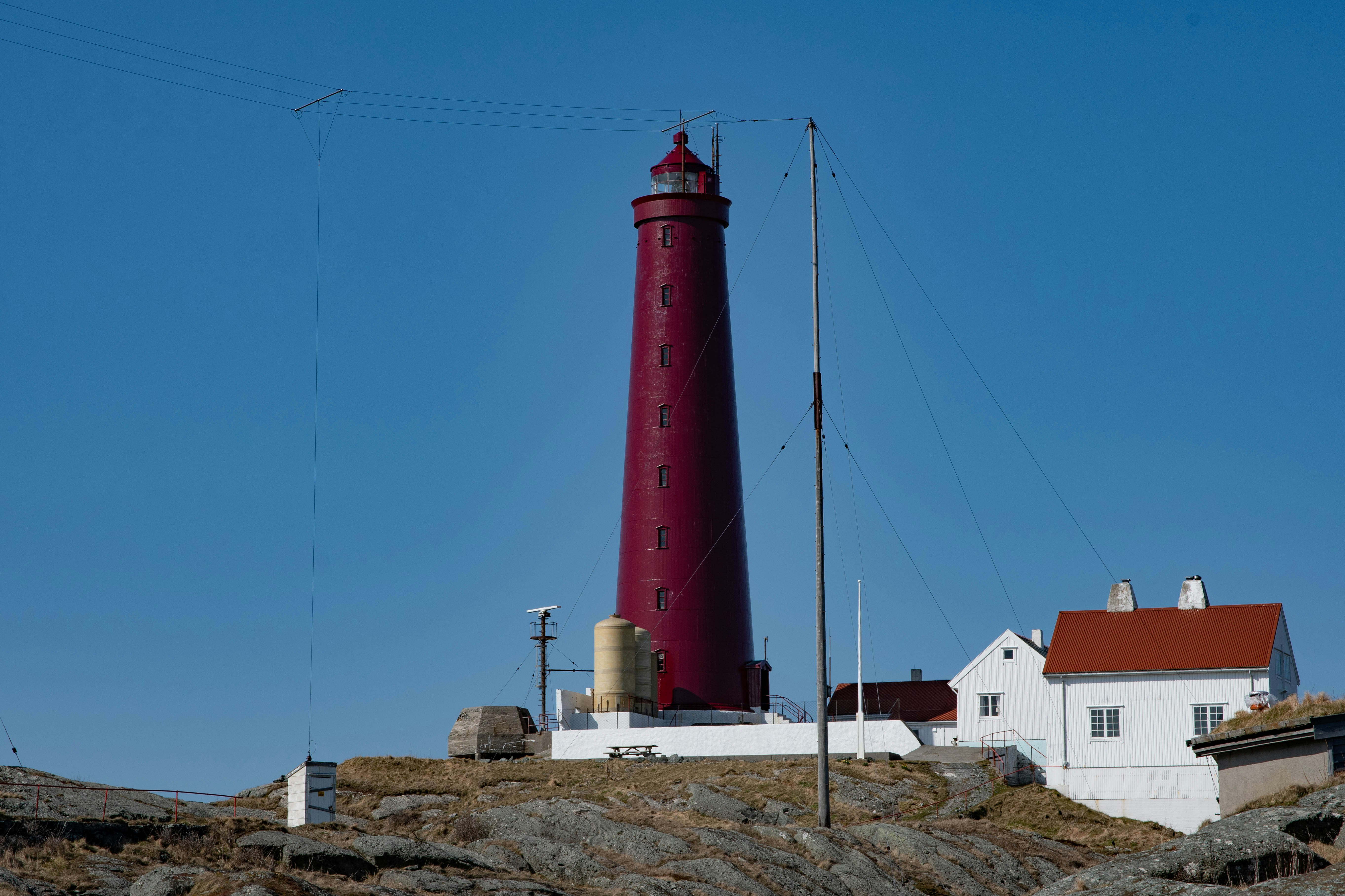 red and white lighthouse under blue sky during daytime