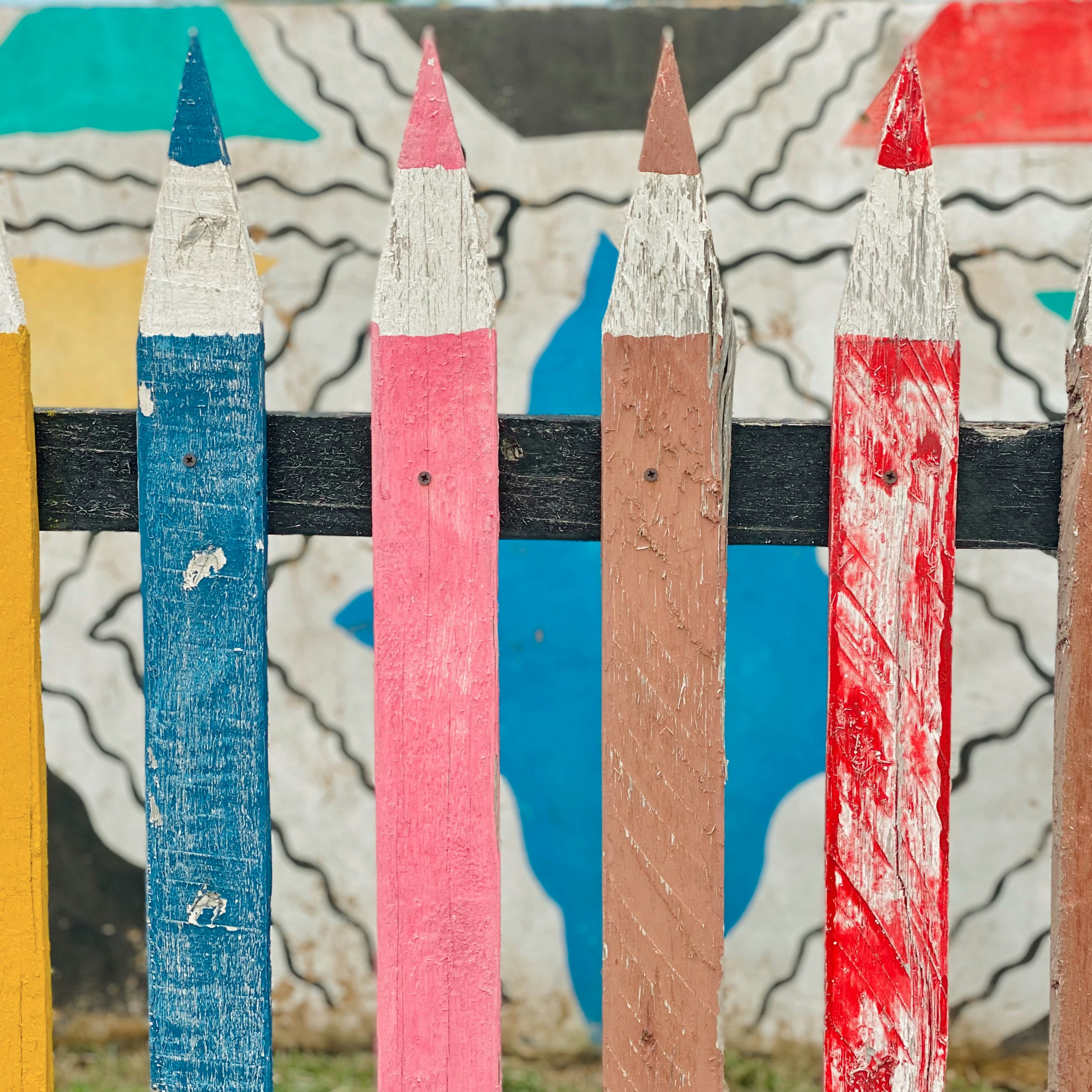 white red and blue striped wooden fence