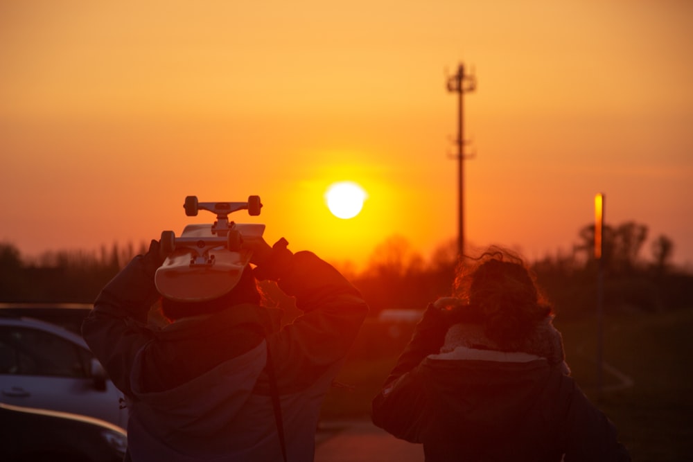 people sitting on the ground during sunset